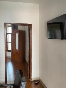 a room with a door and a television on a wall at Hotel new plazza in Kisangani