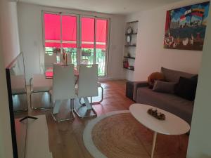 a living room with a couch and a table at Cosy T3, proche centre ville in Aix-en-Provence
