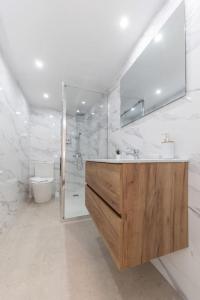 a white bathroom with a sink and a mirror at Modern apartment in Oviedo With Views in Oviedo +14 photos