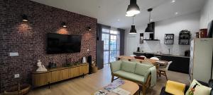 a living room with a brick wall at AniCa II, el lugar de la Mancha in Argamasilla de Alba
