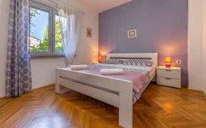 Postel nebo postele na pokoji v ubytování Apartment Eva