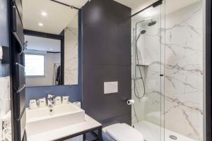 a bathroom with a sink and a shower at Best Western Les Bains Hotel et SPA in Perros-Guirec