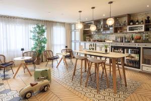 a kitchen and dining room with a table and chairs at Best Western Les Bains Hotel et SPA in Perros-Guirec