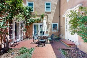 a patio with a table and chairs and an umbrella at Casa Las Rosas in Santa Fe
