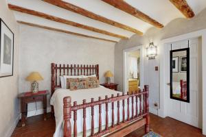 a bedroom with a large bed and two tables at Casa Las Rosas in Santa Fe
