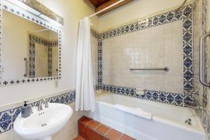 a bathroom with a white tub and a sink at Casa Las Rosas in Santa Fe +18 photos