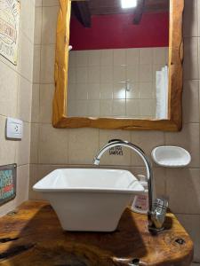 a white sink on a wooden counter in a bathroom at Cabañas Blumenhaus in Villa Ventana +39 photos