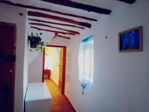 a room with white walls and a wooden ceiling at Cortijo Rural Violeta in Órgiva +6 photos