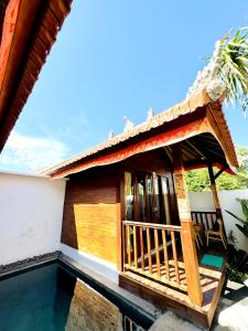 a house with a pool in front of it at Bali Shanti Villa in Uluwatu +14 photos