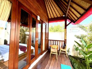 a room with a bedroom and a bed on a wooden deck at Bali Shanti Villa in Uluwatu