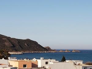 a group of white buildings and the ocean at Résidence Maya in El Haouaria
