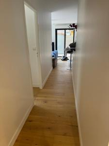 an empty hallway with a wooden floor in a room at Charmant T3 à la plage in Seignosse +11 photos