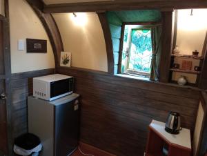 a small kitchen with a microwave on top of a refrigerator at Springfield Cabin in Springfield