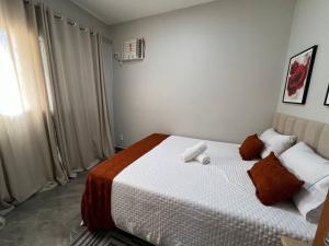 a bedroom with a large bed in a room at Loft Home Vila Bella in Cuiabá +28 photos