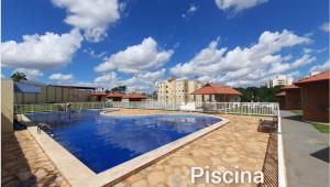 a swimming pool with blue water in a building at Loft Home Vila Bella in Cuiabá