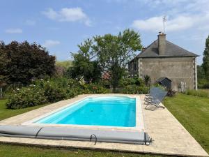 a swimming pool in the yard of a house at Gîte familial rénové avec piscine, jardin de 1 hectare et vélos à disposition, situé en pleine campagne - FR-1-591-579 in Tilly