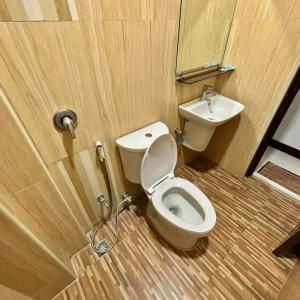 a bathroom with a toilet and a sink at Fatchoi Hotel in General Santos +12 photos