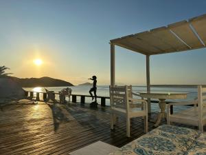a person running on a dock near the ocean at Villa Romana Búzios in Búzios