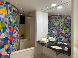 a bathroom with a sink and a mirror at Villa Romana Búzios in Búzios +58 photos