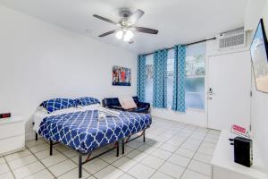 a bedroom with a bed and a ceiling fan at Steps 2 Beach, Prime Ocean Dr Condo w/2 Queen Beds in Miami Beach