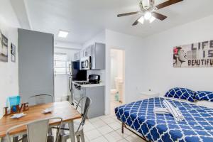 a bedroom with a bed and a table and a kitchen at Steps 2 Beach, Prime Ocean Dr Condo w/2 Queen Beds in Miami Beach