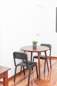 two chairs and a table with a potted plant on it at Solara Art House Hotel in Cusco +70 photos