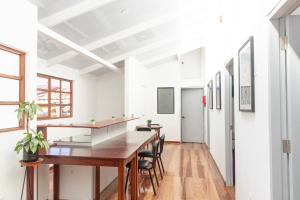 a dining room with a long table and chairs at Solara Art House Hotel in Cusco