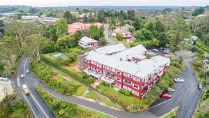 an aerial view of a red house with a street at Mountain Heritage Hotel in Katoomba