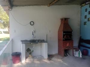 a kitchen with a brick oven in a room at Rancho Ohana in Peruíbe