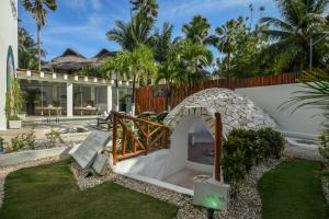 a garden with a stone archway in a yard at El Dorado Casitas Royale, Catamarán, Cenote, All & More Inclusive - Adults Only in Puerto Morelos