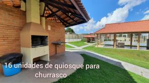a patio with a pizza oven on the side of a house at Loft Home Vila Bella in Cuiabá