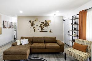 a living room with a couch and a map on the wall at Sky Harbor House - Centrally Located withHot Tub home in Yucca Valley
