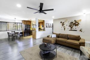 a living room with a couch and a table at Sky Harbor House - Centrally Located withHot Tub home in Yucca Valley