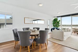 a dining room with a table and chairs at HOWARD ST Panoramic River and Ocean Views - Penthouse -Rooftop in Noosaville