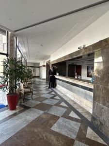 a man standing in the lobby of a building at Atlantic City Apart Service in Salvador +44 photos