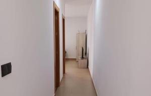 a hallway with a refrigerator in a white room at Awesome Apartment In Alicante With Wifi in Alicante +12 photos
