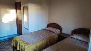 a bedroom with two beds and a mirror at The House Tarija in Tarija