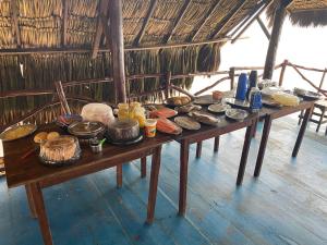 a table with many different types of food on it at Chico Caranguejo da Baleia in Itapipoca