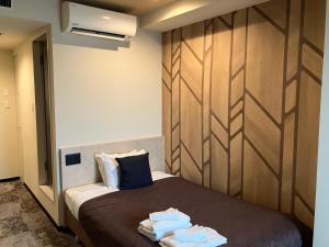 Postel nebo postele na pokoji v ubytování HOTEL LiVEMAX BUDGET Amagasaki