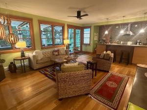 a living room with a couch and chairs and a kitchen at Creekside Setting Right Near Downtown And Bogert Park in Bozeman