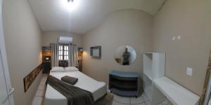 a small room with a bed and a staircase at Casa temporada Araçoiaba in Araçoiaba