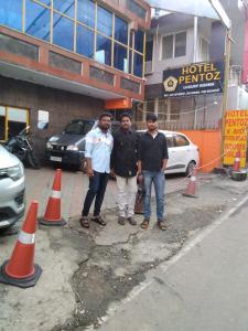 a group of three men standing in front of cones at Hotel PENTOZ - Rose Garden, Ooty in Ooty