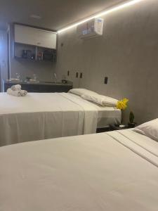 a hotel room with two beds and a mirror at Blue Sunset Flats Beira Mar - Apt 217 in João Pessoa +15 photos