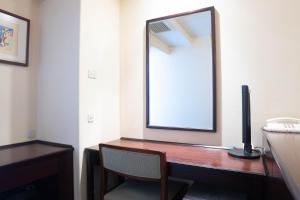 a room with a desk with a mirror and a chair at Shinagawa Prince Hotel East Tower in Tokyo