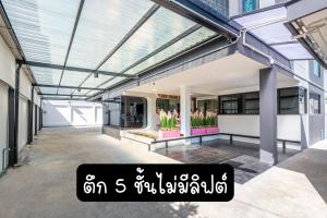 a building with a glass ceiling and flowers in a courtyard at Panvadee Boutique House in Ban Bang Phang