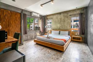 a bedroom with a bed in a room with windows at UNOTEL Karon Beach in Karon Beach
