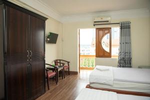 Kiều SơnにあるNgọc Hà Hotel 1のベッドが2つと窓があるホテルの部屋