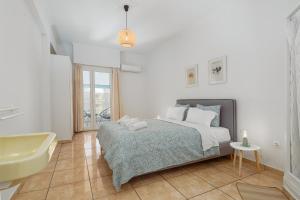 a bedroom with a bed and a sink and a tub at Eirini Residence in Athens
