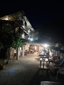 a group of people sitting at a table at night at Vila Andra in Costinesti