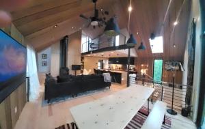 a living room with a couch and a tv at This Deluxe Modern New 3-Story Home With Central Ac Offers The Best Of Bozeman! in Bozeman